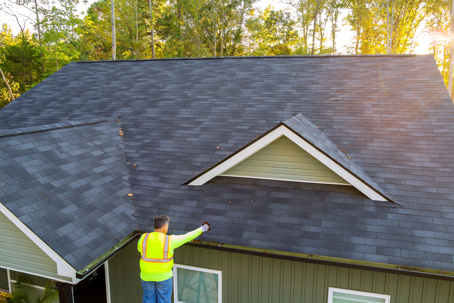 worker checking roof for imperfections