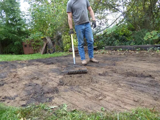 Man raking soil